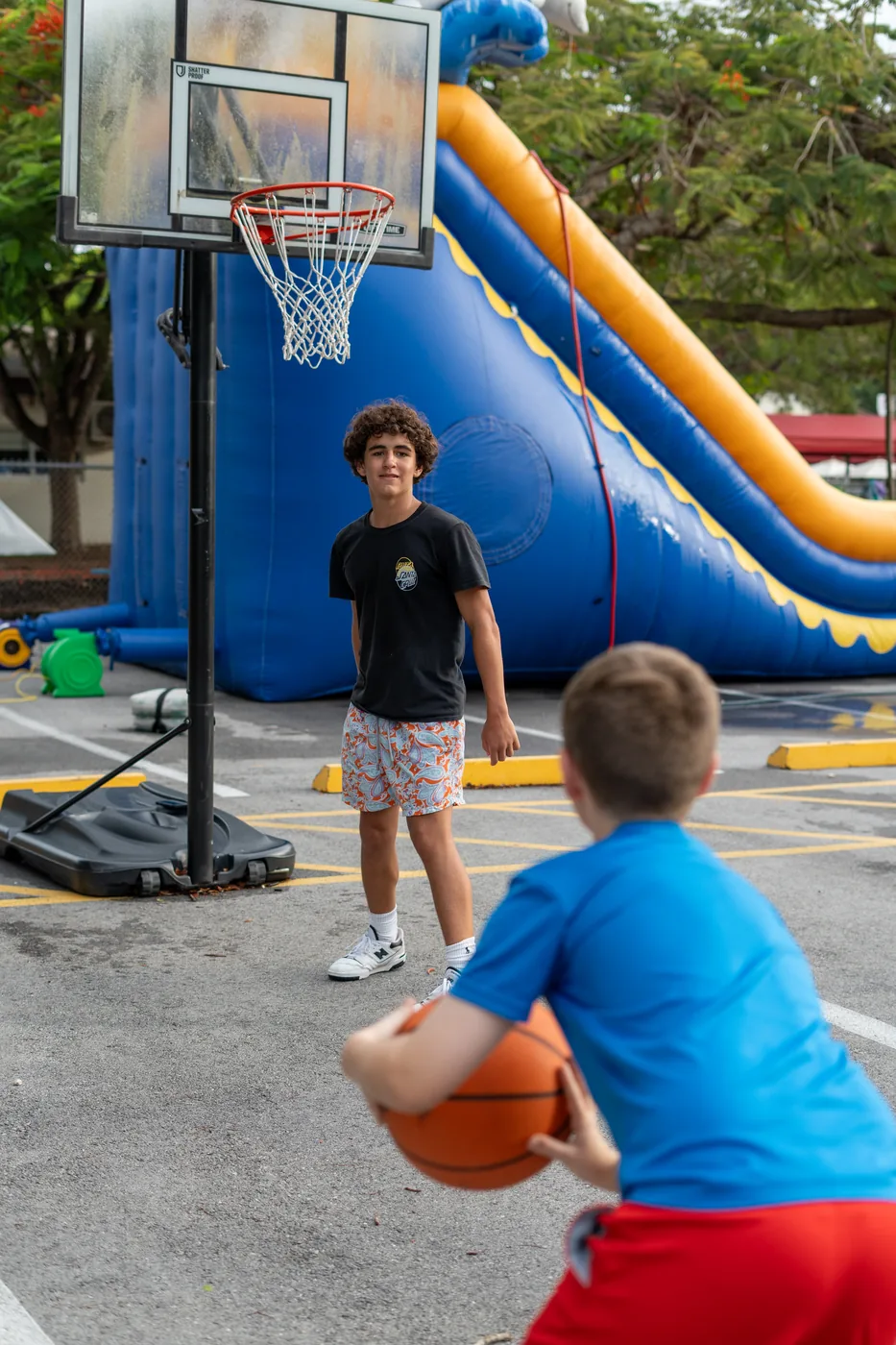 Children lining up beside an inflatable slide at a Christchurch Kids event