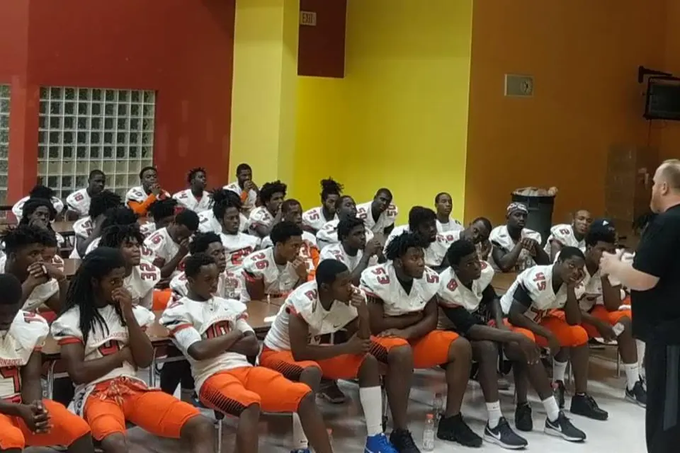 Booker T. Washington football players gathered for a team talk