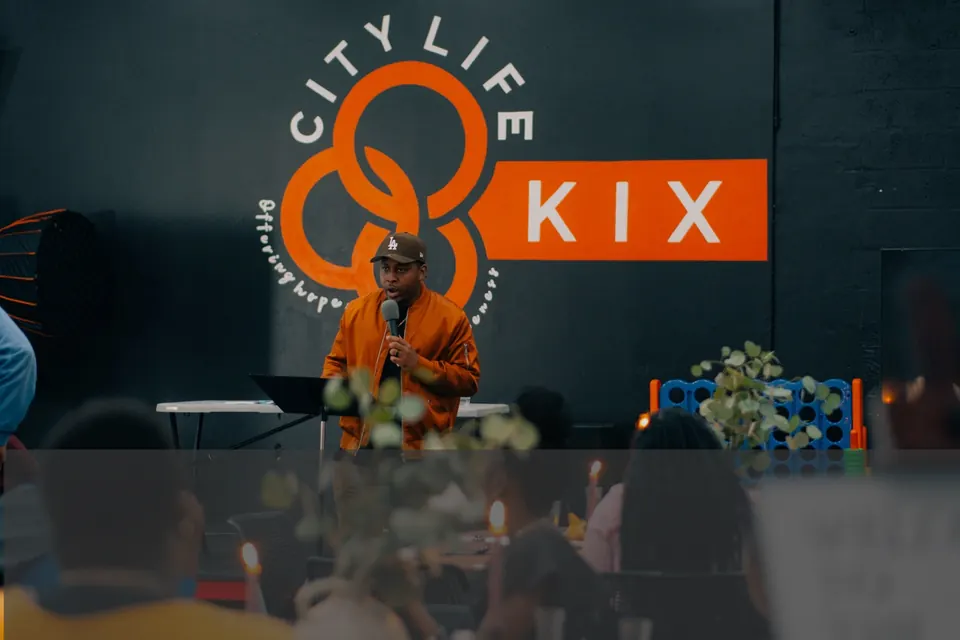 A speaker on stage at a City Life KIX event