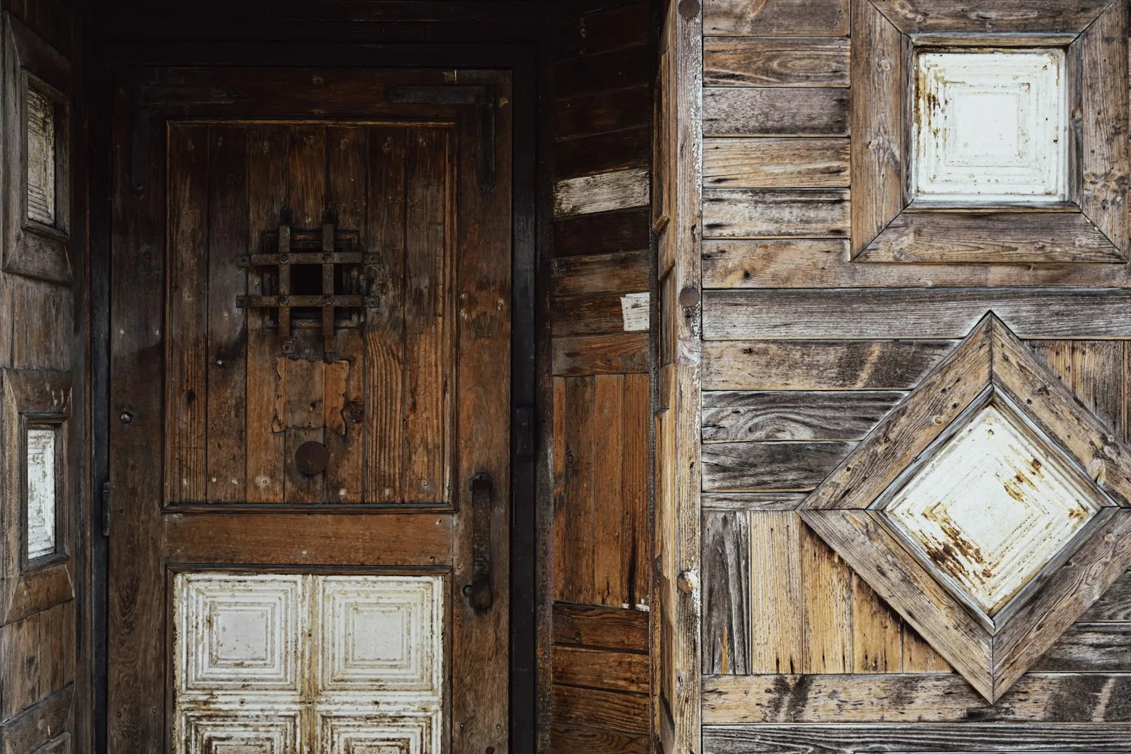 A weathered wooden door, closed.